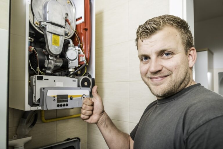 repair man fixing furnace