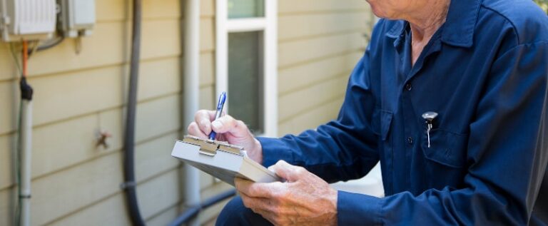 technician checking hvac unit